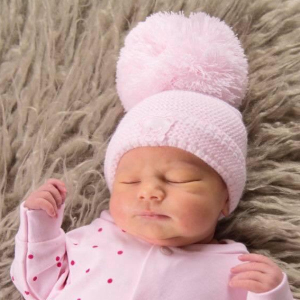 Sleeping baby wearing the first size teddy embroidered hat