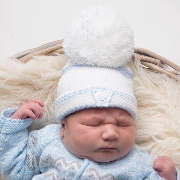 Baby wearing first size embroidered teddy hat in white & blue